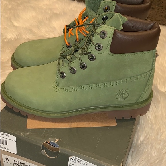 green timbs with orange laces